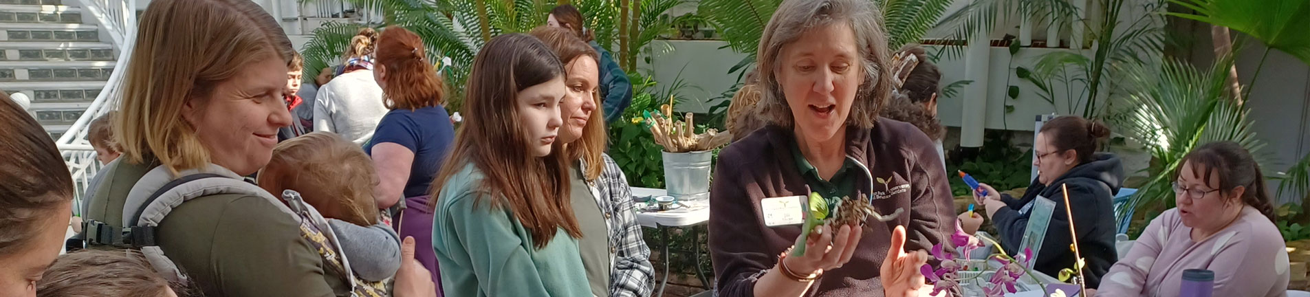 botanical gardens staff explaining information on flowers