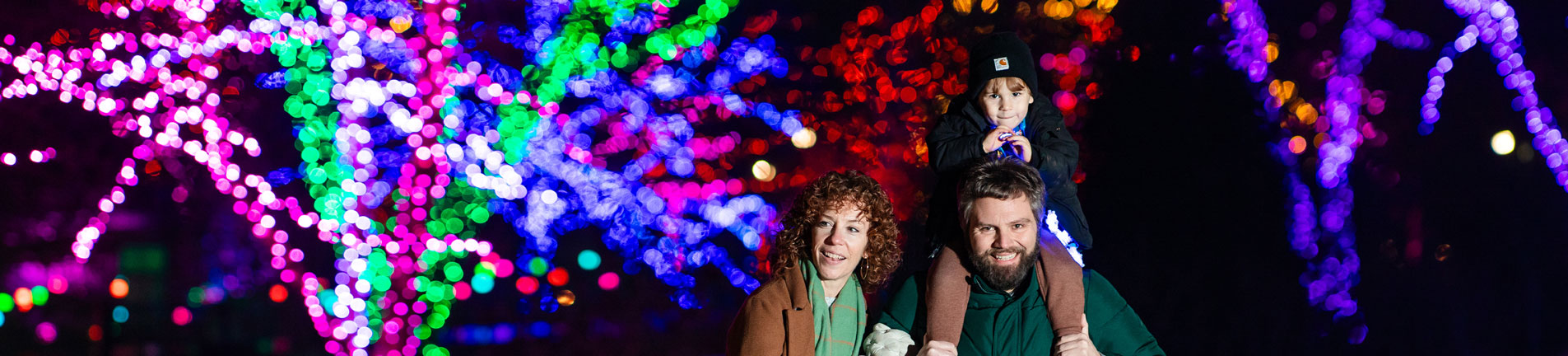 family in the garden in the holidays with holiday lights
