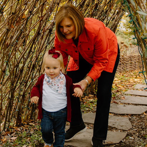 mother and child walking through an arch