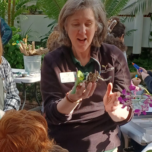 botanical gardens staff explaining information on flowers